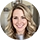 Portrait of Angie, a SnapSort AI user, smiling with blonde wavy hair indoors