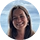 Portrait of Awwwnya, a SnapSort AI user, smiling with brunette hair and pearl earrings against a blue sky